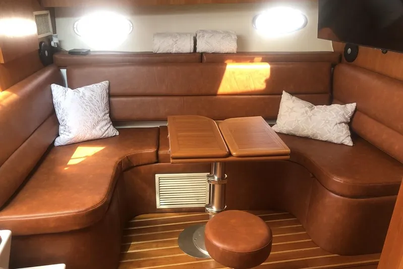  Yacht Photos Pics 1998 Tiara Yachts 3700 Open interior with brown leather seating and wooden table.
