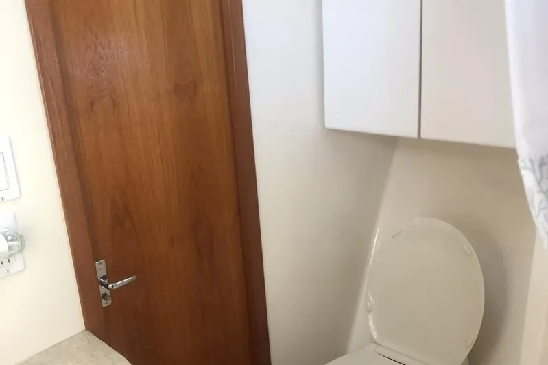  Yacht Photos Pics Bathroom interior of 1998 Tiara Yachts 3700 Open, featuring wooden door and toilet.