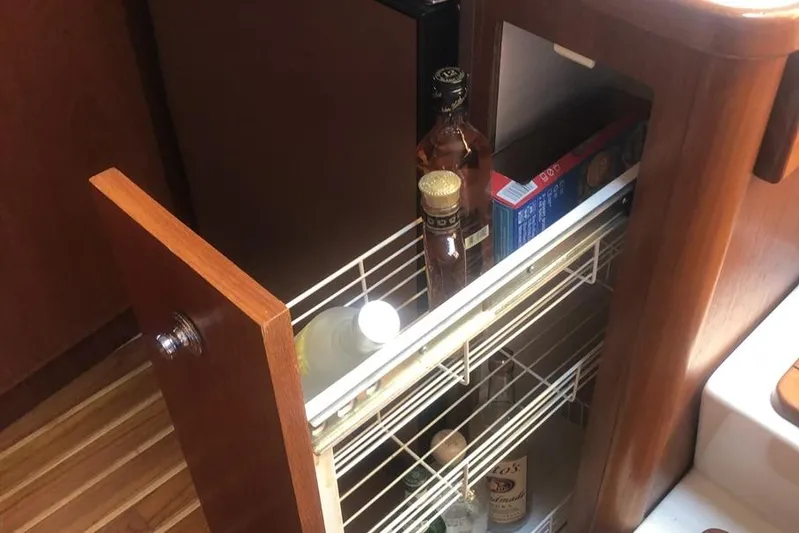  Yacht Photos Pics 1998 Tiara Yachts 3700 Open interior with pull-out pantry and wooden cabinetry.