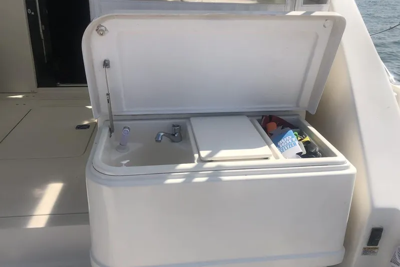  Yacht Photos Pics 1998 Tiara Yachts 3700 Open boat sink and storage compartment on deck.