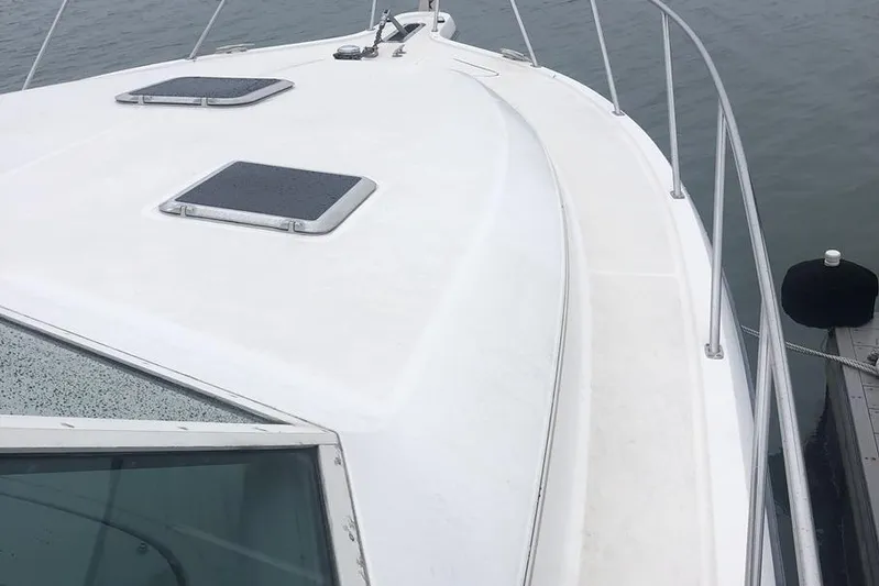  Yacht Photos Pics 1998 Tiara Yachts 3700 Open boat deck with railing and hatches.