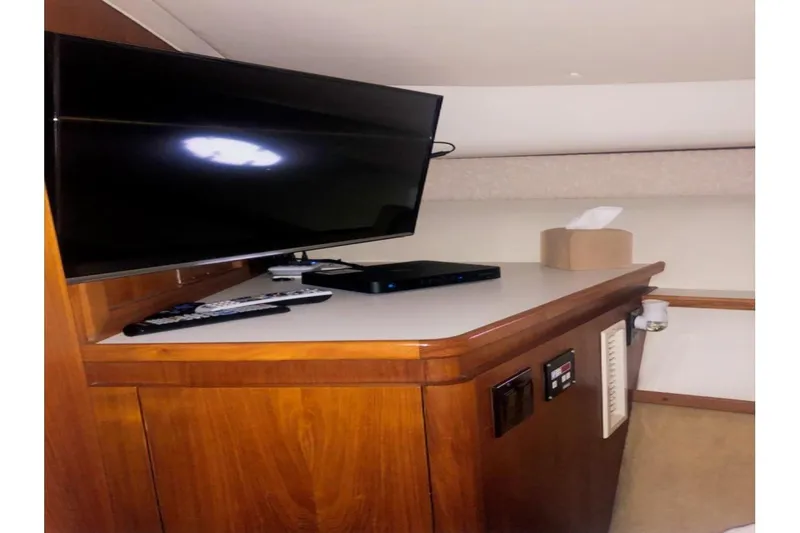  Yacht Photos Pics Interior of 1998 Tiara Yachts 3700 Open with TV and wooden cabinetry.