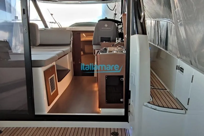 Natasha Yacht Photos Pics Interior view of 2019 Jeanneau Merry Fisher 895 boat, featuring seating and helm.