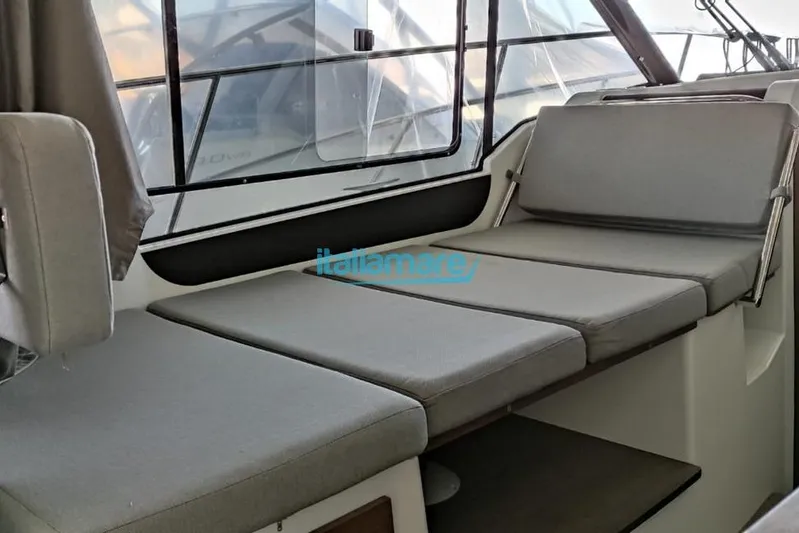 Natasha Yacht Photos Pics 2019 Jeanneau Merry Fisher 895 interior seating area with gray cushions.