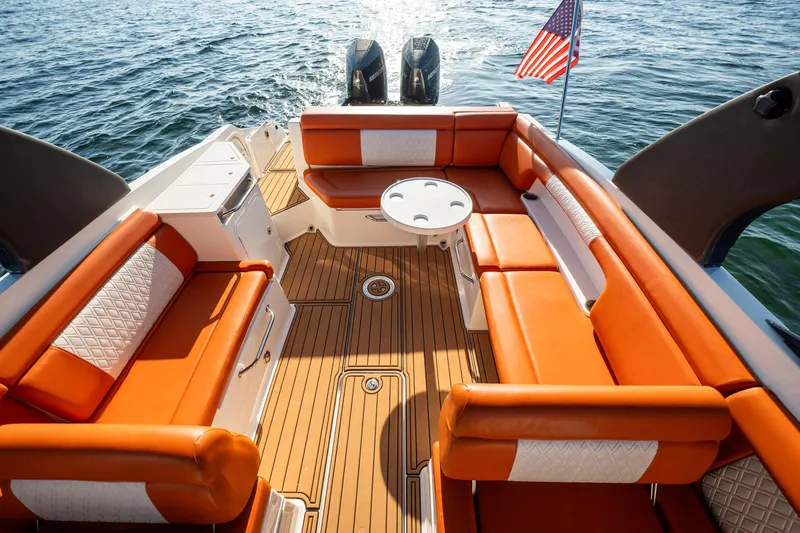 Ceci Yacht Photos Pics 2019 Sea Ray SDX 290 Outboard boat with orange seating and American flag on water.