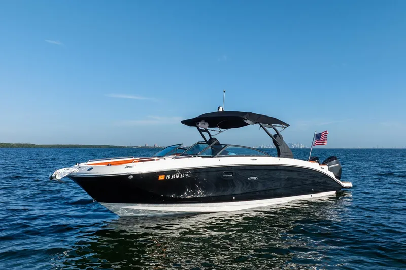 Ceci Yacht Photos Pics 2019 Sea Ray SDX 290 Outboard boat on open water, clear sky, American flag.