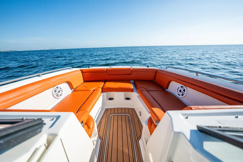 Ceci Yacht Photos Pics 2019 Sea Ray SDX 290 Outboard boat with orange seating, cruising on open water.
