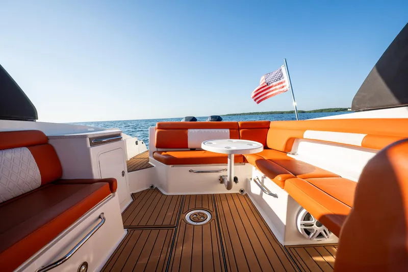 Ceci Yacht Photos Pics 2019 Sea Ray SDX 290 Outboard boat interior with orange seating and American flag.