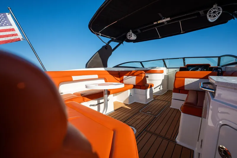 Ceci Yacht Photos Pics 2019 Sea Ray SDX 290 Outboard boat interior with orange seating and American flag.