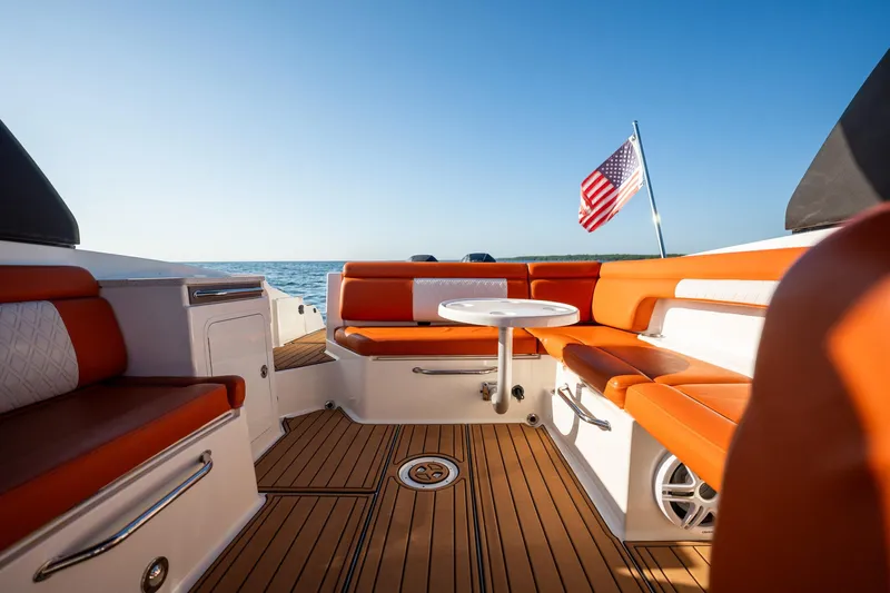 Ceci Yacht Photos Pics 2019 Sea Ray SDX 290 Outboard boat interior with orange seating and American flag.