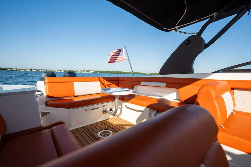 Ceci Yacht Photos Pics 2019 Sea Ray SDX 290 Outboard boat interior with orange seating and American flag.