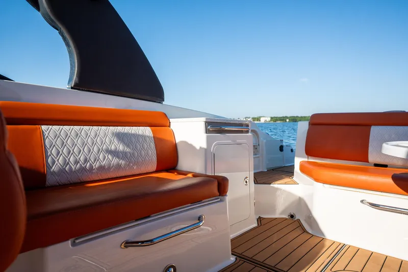 Ceci Yacht Photos Pics 2019 Sea Ray SDX 290 Outboard interior with orange seating and wood flooring.