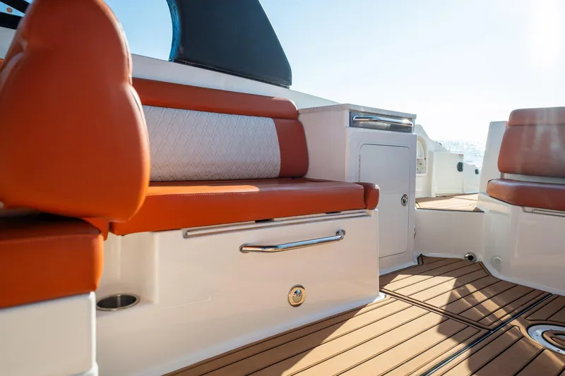 Ceci Yacht Photos Pics 2019 Sea Ray SDX 290 Outboard interior with orange seating and teak flooring.