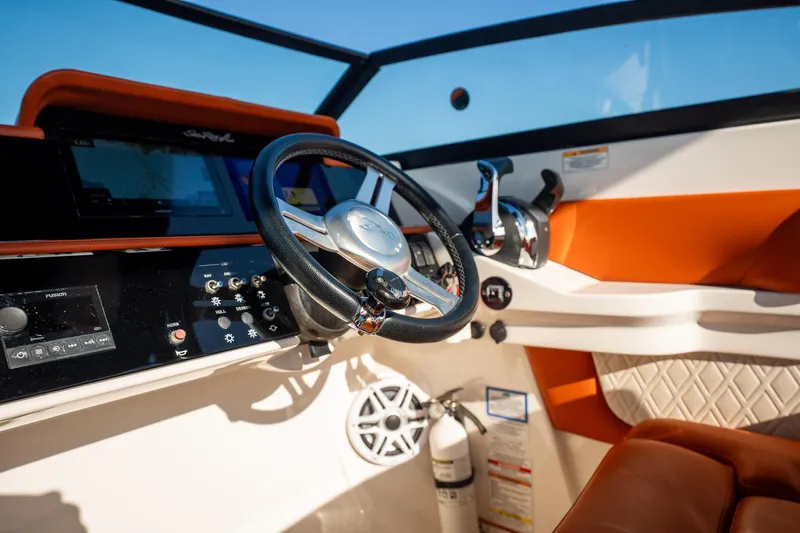 Ceci Yacht Photos Pics 2019 Sea Ray SDX 290 Outboard helm with steering wheel, controls, and navigation display.