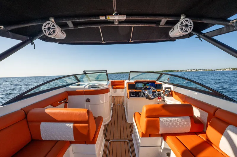 Ceci Yacht Photos Pics 2019 Sea Ray SDX 290 Outboard boat interior with orange seating, on open water.