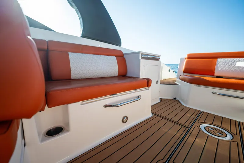 Ceci Yacht Photos Pics 2019 Sea Ray SDX 290 Outboard interior with orange seating and teak flooring.