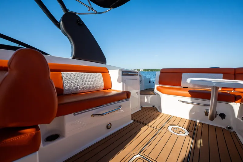 Ceci Yacht Photos Pics 2019 Sea Ray SDX 290 Outboard interior with orange seating and wooden deck.