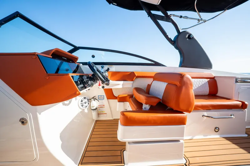 Ceci Yacht Photos Pics 2019 Sea Ray SDX 290 Outboard interior with orange seating and modern dashboard.