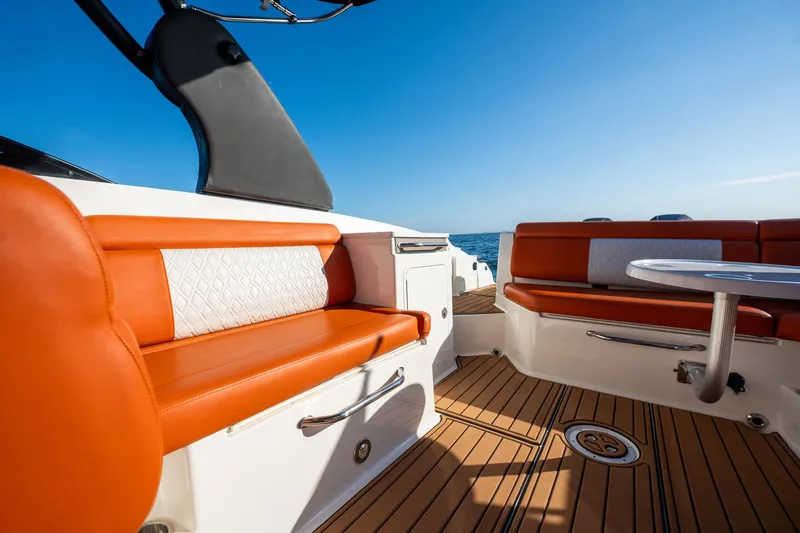 Ceci Yacht Photos Pics 2019 Sea Ray SDX 290 Outboard interior with orange seating and ocean view.