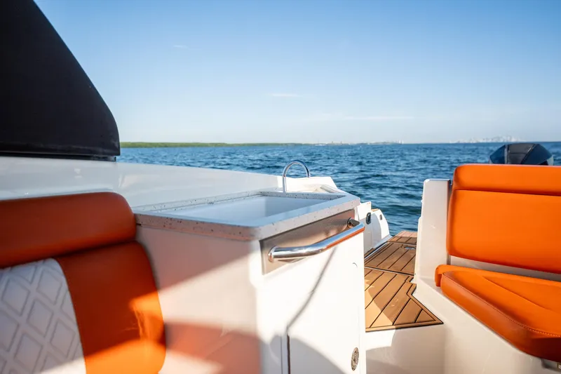 Ceci Yacht Photos Pics 2019 Sea Ray SDX 290 Outboard boat interior with orange seating and ocean view.