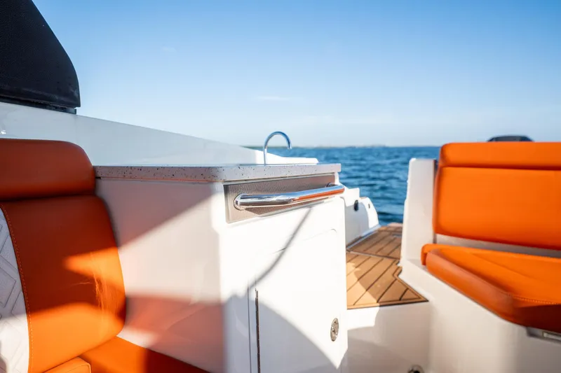 Ceci Yacht Photos Pics 2019 Sea Ray SDX 290 Outboard interior with orange seating and ocean view.