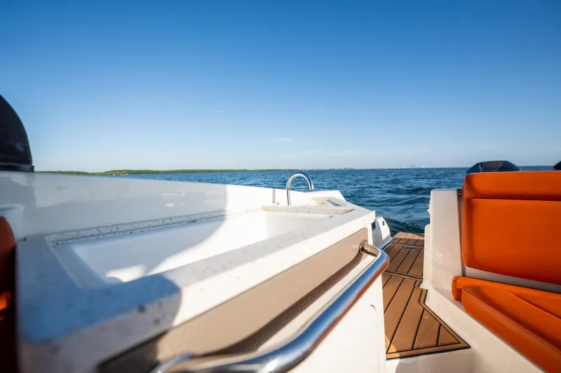Ceci Yacht Photos Pics 2019 Sea Ray SDX 290 Outboard boat with orange seating, cruising on open water.