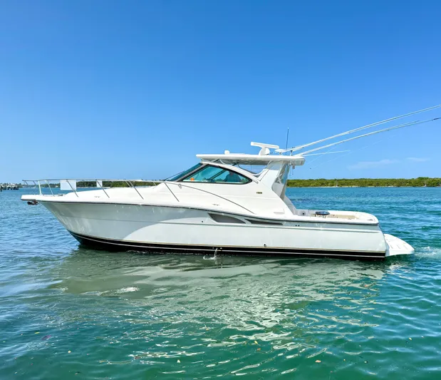 Legacy Yacht Photos Pics 2003 Tiara Yachts 4200 Open cruising on clear blue waters.