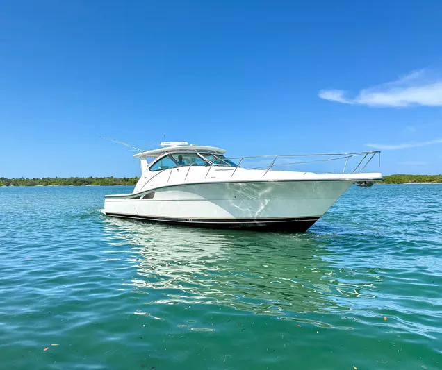 Legacy Yacht Photos Pics 2003 Tiara Yachts 4200 Open cruising on clear blue water under a sunny sky.