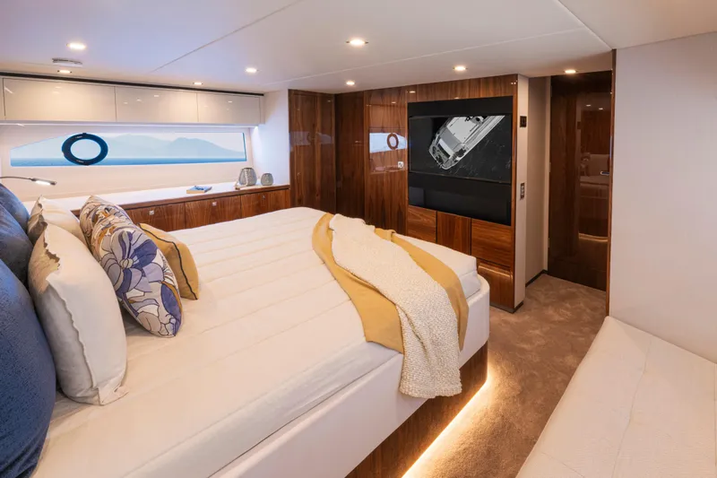  Yacht Photos Pics Luxurious bedroom interior of 2026 Riviera 5600 Sport Yacht Platinum Edition.