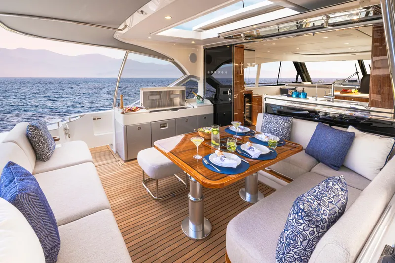  Yacht Photos Pics Luxurious 2026 Riviera 5600 Sport Yacht Platinum Edition with elegant outdoor dining area.
