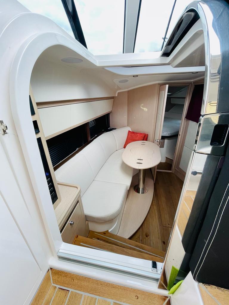Interior of 2021 Focus Power 36 yacht with modern seating and wooden flooring.