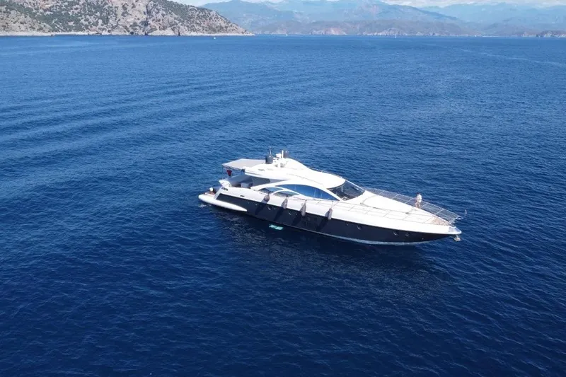  Yacht Photos Pics 2007 Azimut 86S yacht cruising on open blue sea with scenic mountain backdrop.