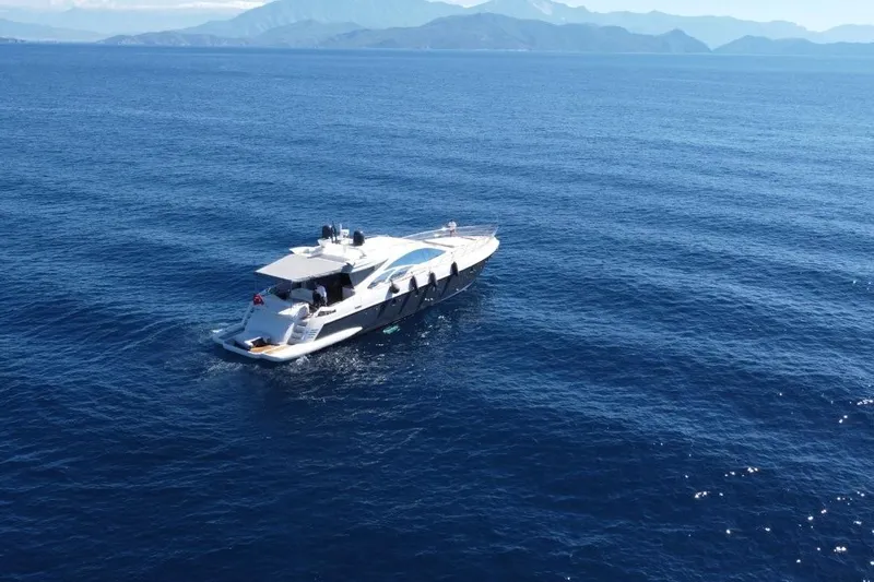  Yacht Photos Pics 2007 Azimut 86S yacht cruising on open blue sea with distant mountains.