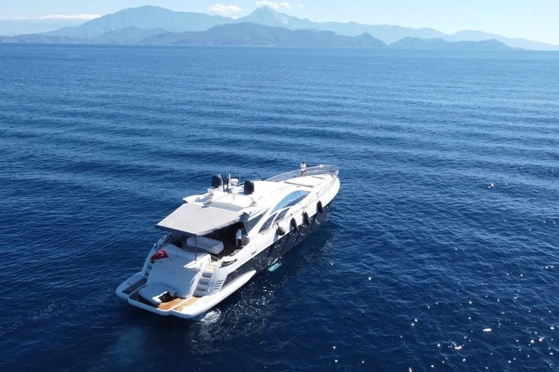  Yacht Photos Pics 2007 Azimut 86S yacht cruising on open sea with mountainous backdrop.