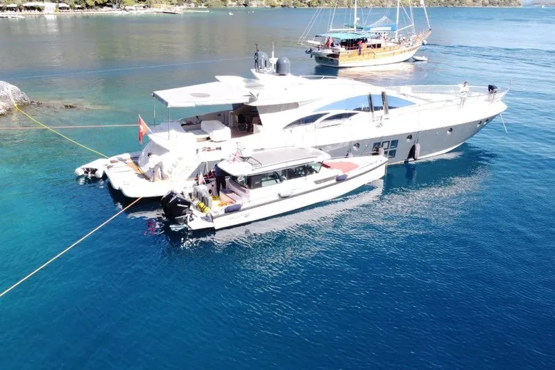  Yacht Photos Pics 2007 Azimut 86S yacht anchored in clear blue waters, with smaller boats nearby.