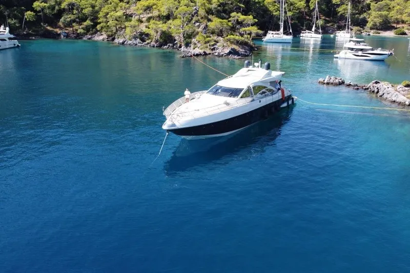  Yacht Photos Pics 2007 Azimut 86S yacht anchored in a serene, turquoise bay with surrounding boats.