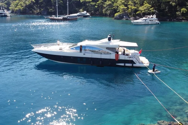  Yacht Photos Pics Luxury 2007 Azimut 86S yacht anchored in clear blue waters, surrounded by lush greenery.