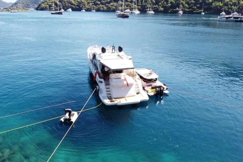  Yacht Photos Pics Luxury 2007 Azimut 86S yacht anchored in a scenic bay with clear blue waters.