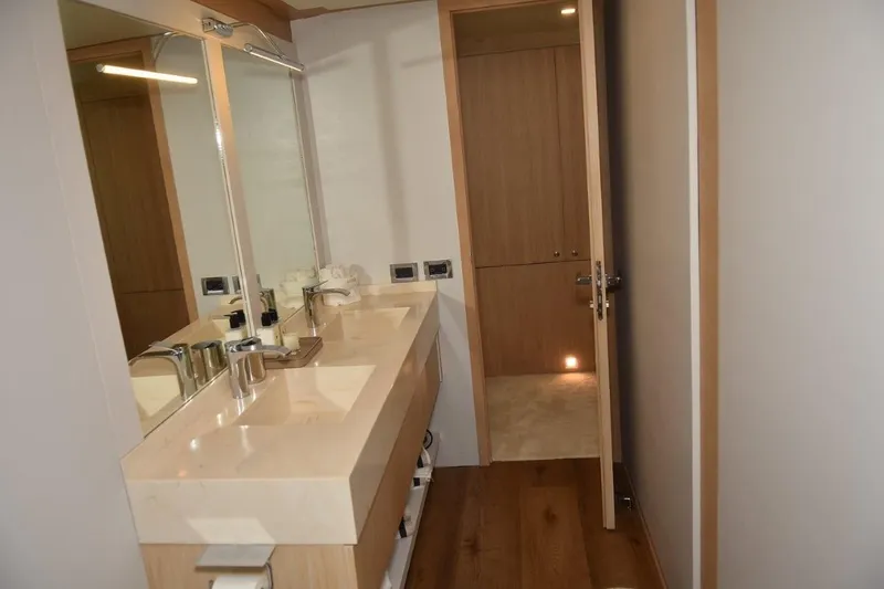  Yacht Photos Pics Luxurious bathroom interior of 2007 Azimut 86S yacht with modern fixtures and wooden accents.