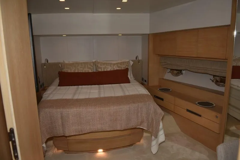  Yacht Photos Pics Luxurious bedroom interior of 2007 Azimut 86S yacht with elegant wood furnishings.