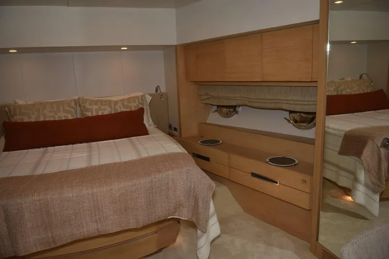  Yacht Photos Pics Luxurious bedroom interior of 2007 Azimut 86S yacht with elegant wood finishes.