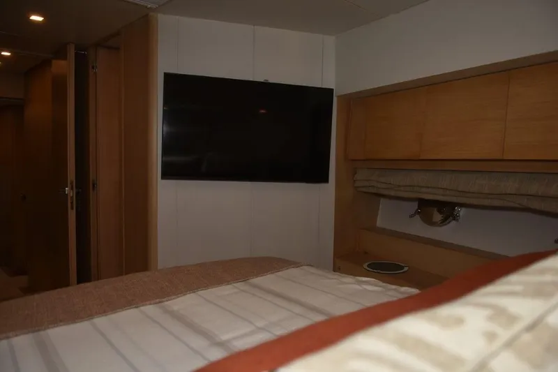  Yacht Photos Pics Interior of 2007 Azimut 86S yacht bedroom with TV and wooden cabinetry.