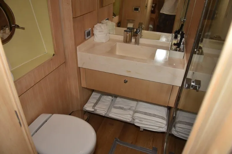  Yacht Photos Pics Luxurious bathroom in 2007 Azimut 86S yacht with modern fixtures and wooden cabinetry.