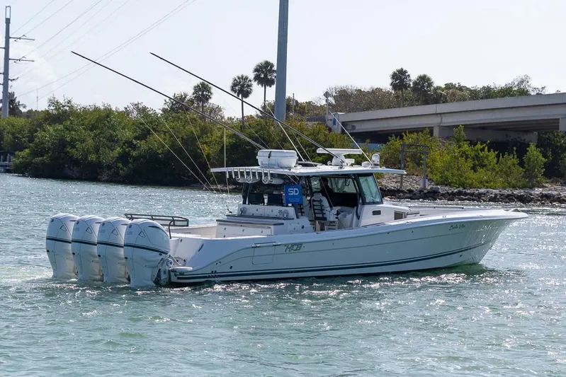  Yacht Photos Pics 2019 HCB 53 Sueños boat with four engines cruising on a sunny waterway.