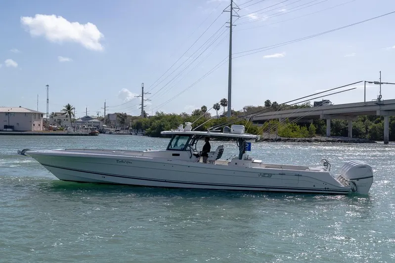  Yacht Photos Pics 2019 HCB 53 Sueños boat cruising on a sunny day near a bridge.