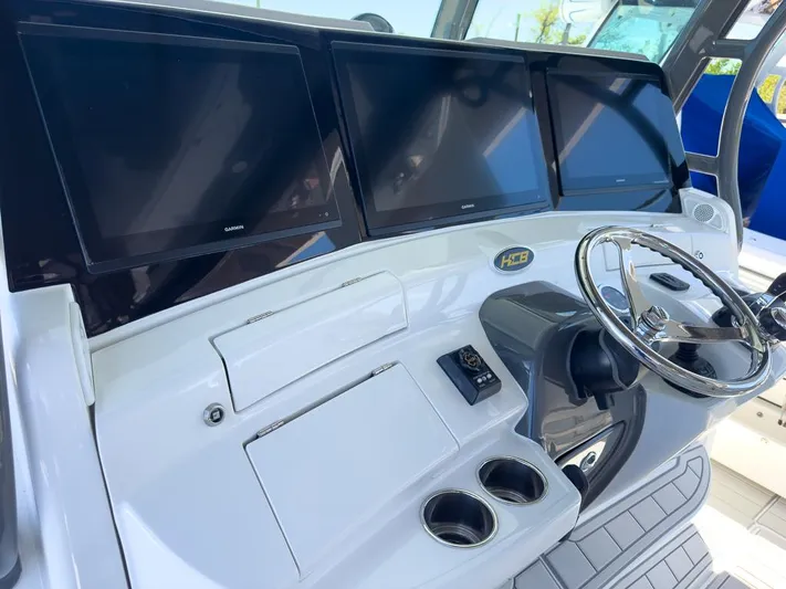  Yacht Photos Pics 2019 HCB 53 Sueños boat dashboard with three screens and steering wheel.