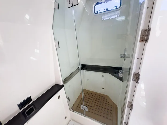  Yacht Photos Pics 2019 HCB 53 Sueños yacht bathroom with glass shower enclosure and modern fixtures.
