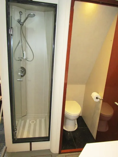 Family Tradition II Yacht Photos Pics Compact bathroom with shower and toilet on a 2012 Neptunus Enclosed Bridge yacht.