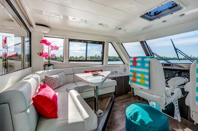 Family Tradition II Yacht Photos Pics Luxurious 2012 Neptunus Enclosed Bridge yacht interior with modern seating and vibrant decor.