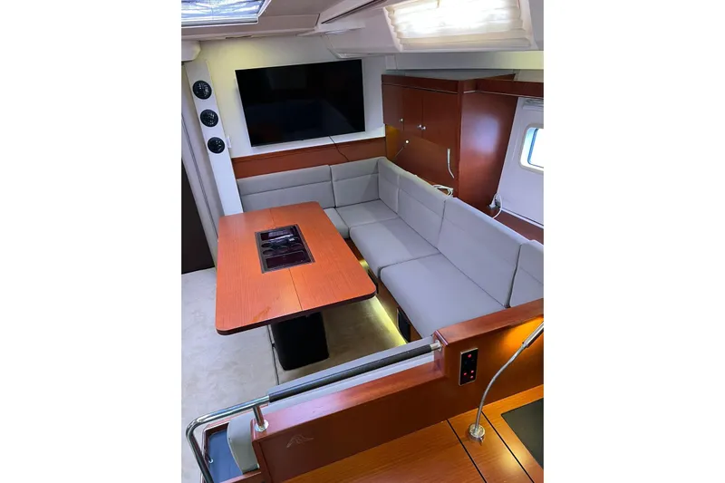  Yacht Photos Pics Luxurious interior of 2013 Hanse 575 yacht with modern seating and dining area.